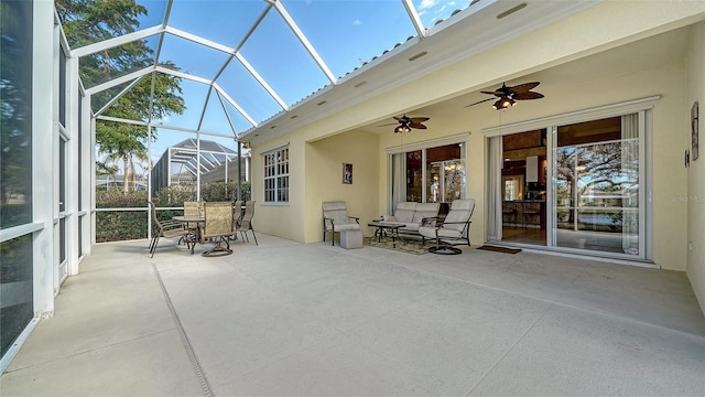 unfurnished sunroom with ceiling fan