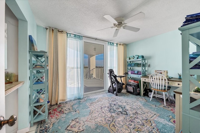 home office featuring ceiling fan and a textured ceiling