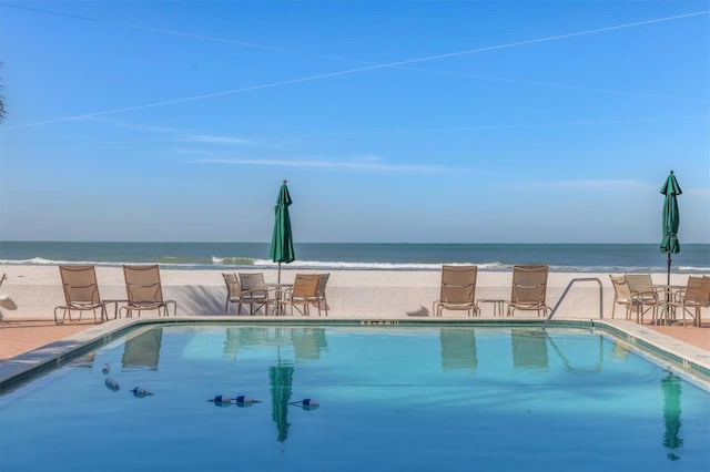 view of swimming pool with a water view