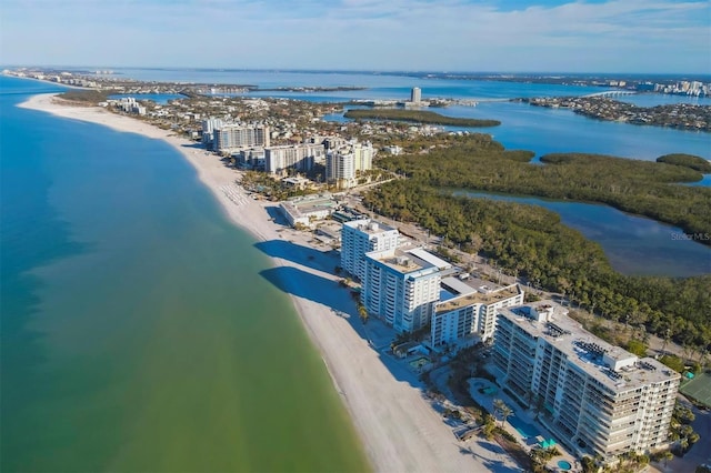 aerial view with a water view and a beach view