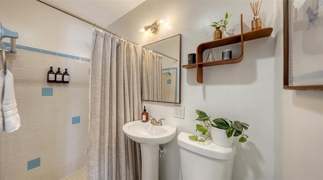 bathroom featuring curtained shower and toilet