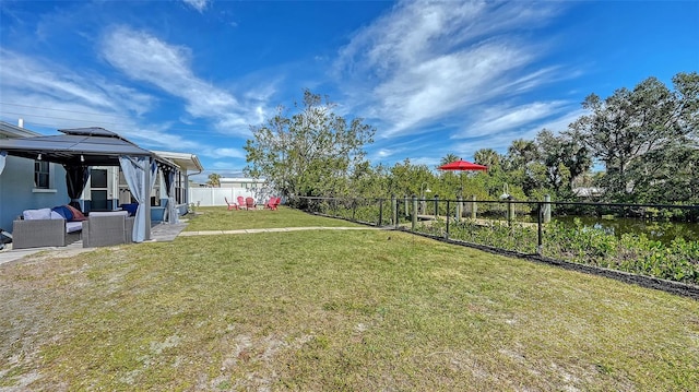 view of yard with an outdoor living space and a gazebo