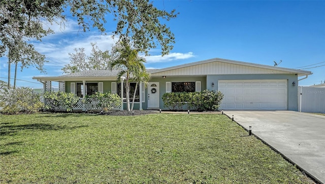 single story home with a front lawn, fence, an attached garage, and concrete driveway