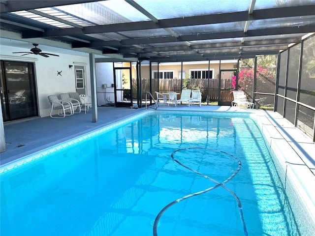 outdoor pool featuring a patio area, a lanai, a ceiling fan, and fence