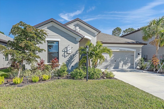 view of front of house featuring a garage and a front lawn