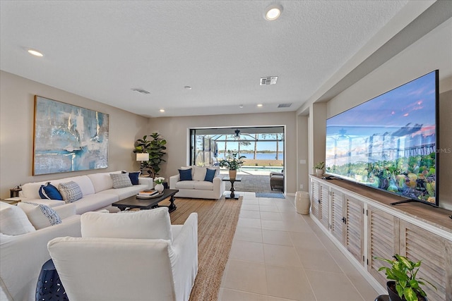 living room with light tile patterned flooring and a textured ceiling