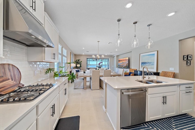 kitchen featuring pendant lighting, white cabinetry, and stainless steel appliances