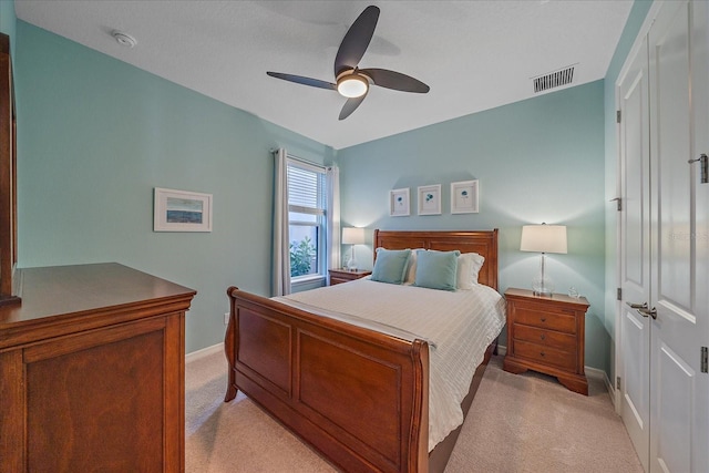 carpeted bedroom with a closet and ceiling fan