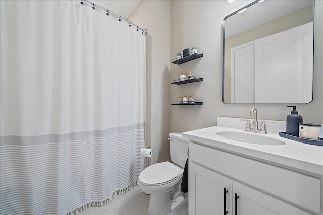 bathroom featuring vanity, toilet, and tile patterned flooring