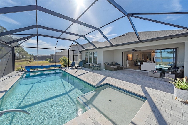 view of swimming pool with a patio, outdoor lounge area, ceiling fan, and glass enclosure