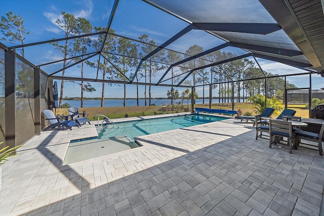 view of pool with a patio area, a water view, and glass enclosure