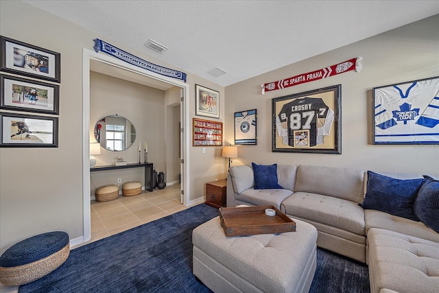 tiled living room featuring a textured ceiling