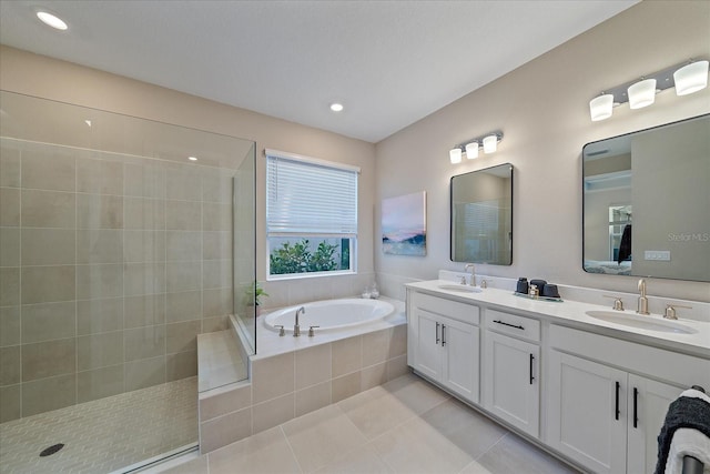 bathroom featuring tile patterned flooring, vanity, and plus walk in shower