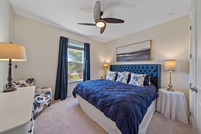 bedroom featuring light colored carpet and ceiling fan