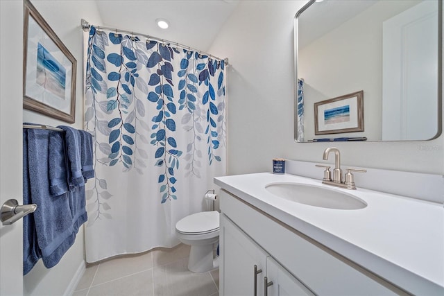 bathroom featuring tile patterned flooring, vanity, and toilet