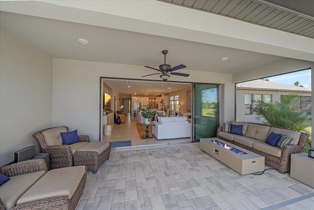 view of patio / terrace featuring an outdoor living space with a fire pit and ceiling fan