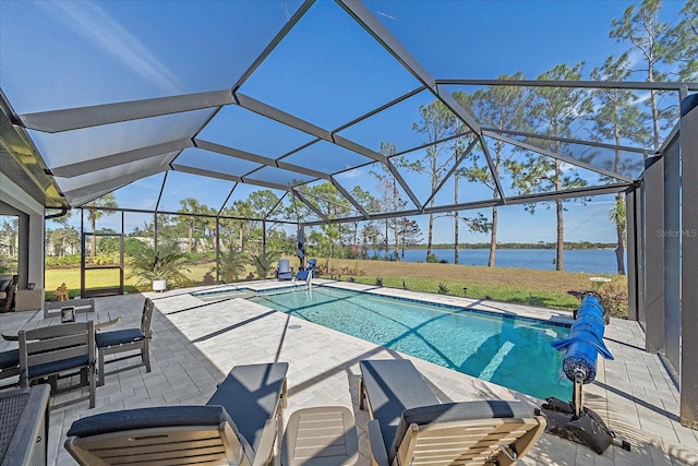 view of swimming pool with a patio area, a water view, and glass enclosure