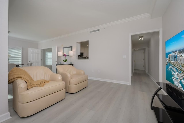 living room with crown molding and light wood-type flooring