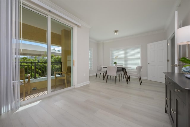 dining room with crown molding and light hardwood / wood-style flooring