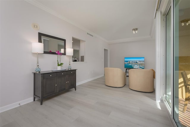 interior space with light hardwood / wood-style flooring and ornamental molding