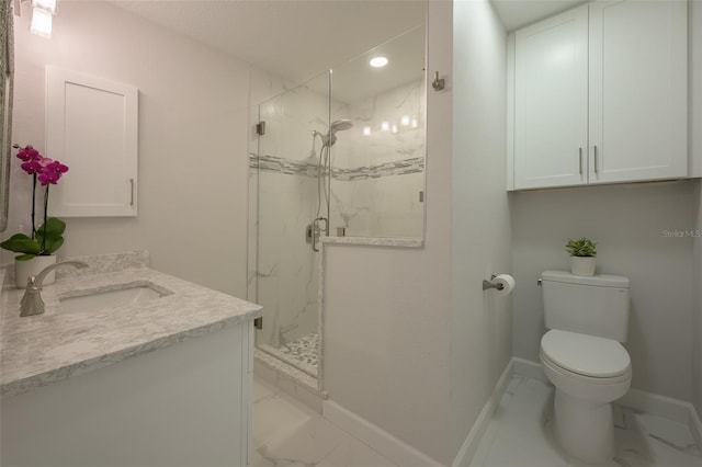 bathroom with vanity, toilet, and a shower with shower door