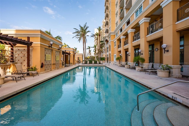 view of swimming pool featuring a patio and a pergola