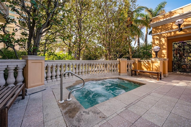 view of pool with an in ground hot tub and a patio