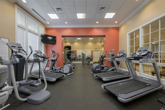 exercise room with a drop ceiling and crown molding