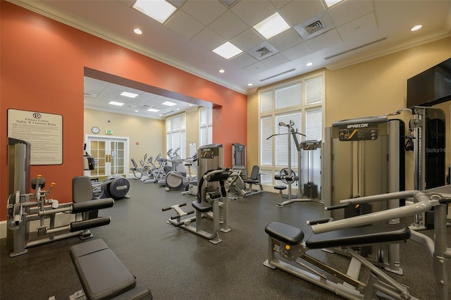 workout area featuring ornamental molding and a drop ceiling