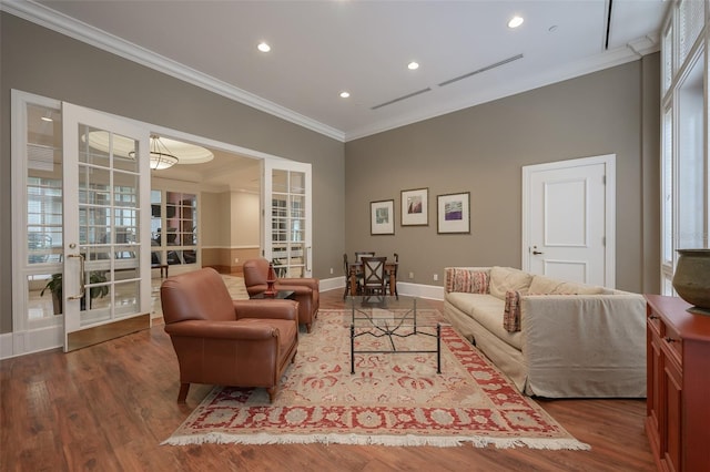 living room with crown molding, hardwood / wood-style floors, and french doors