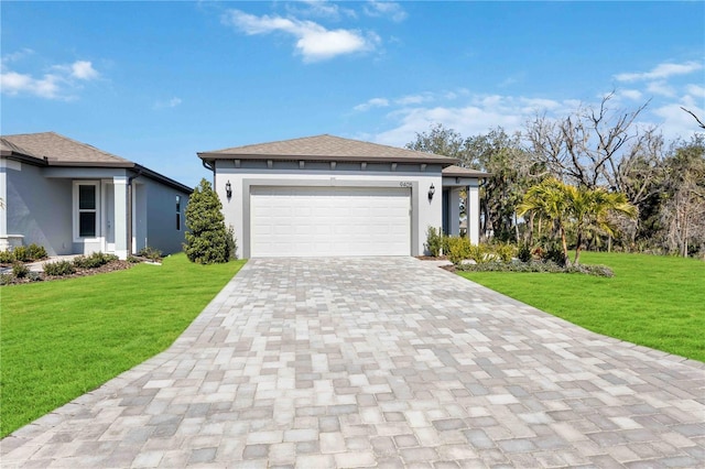 view of front of property with a garage and a front lawn