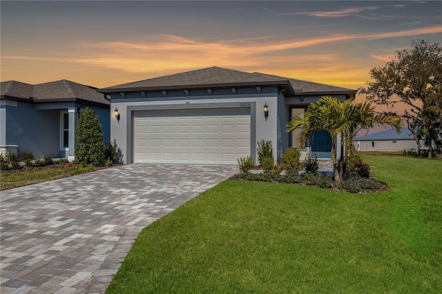 view of front facade with a garage and a yard