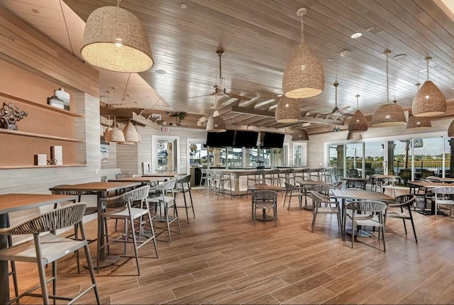 dining area featuring wood-type flooring and wooden ceiling