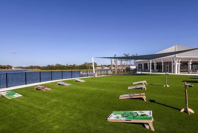 surrounding community with a yard and a water view