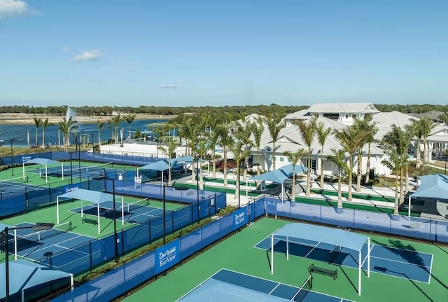 view of tennis court with a water view