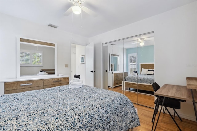 bedroom featuring wood-type flooring, a closet, and ceiling fan