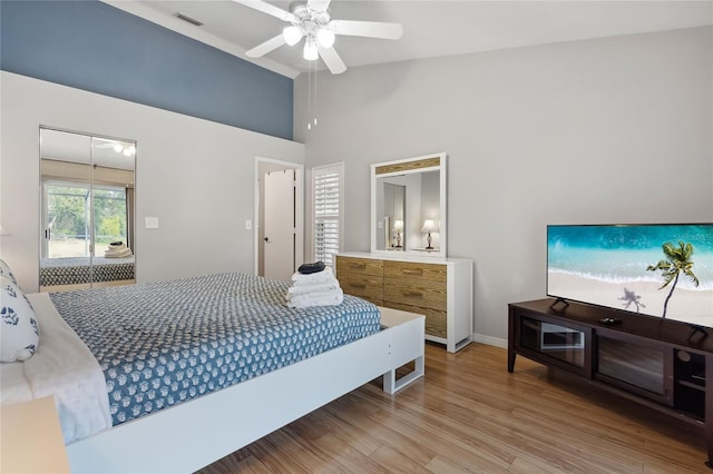 bedroom featuring high vaulted ceiling, ceiling fan, and light hardwood / wood-style flooring