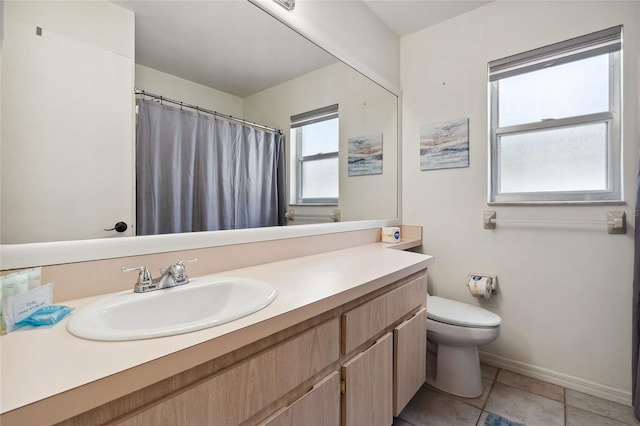 bathroom featuring tile patterned floors, vanity, and toilet