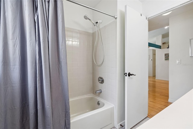 bathroom with wood-type flooring and shower / bathtub combination with curtain