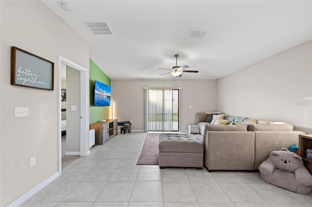 living room featuring visible vents, ceiling fan, baseboards, and light tile patterned flooring