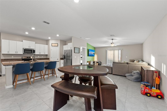 dining room with light tile patterned floors, visible vents, a ceiling fan, and recessed lighting