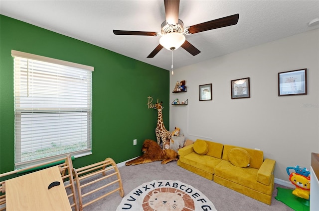 playroom with a healthy amount of sunlight, carpet, baseboards, and a textured ceiling