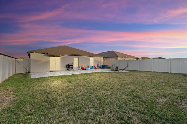 back of house with an outdoor fire pit, central AC unit, a lawn, a patio, and a fenced backyard