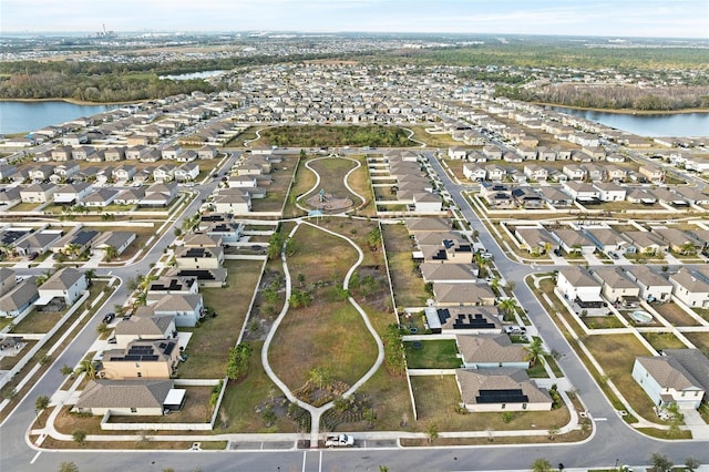 drone / aerial view featuring a residential view and a water view