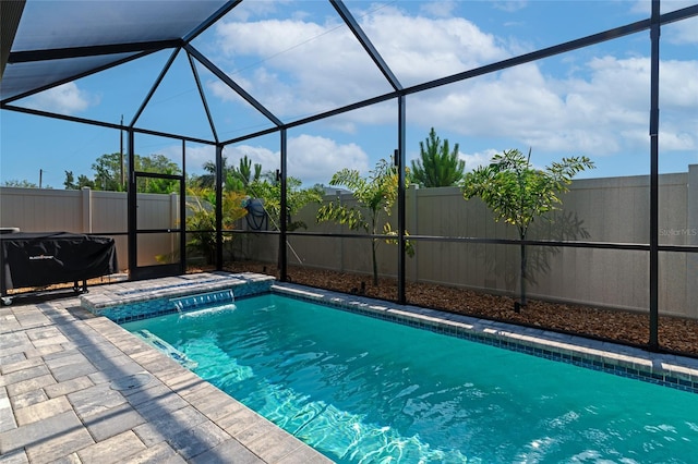 view of swimming pool with a lanai, a fenced backyard, and a patio