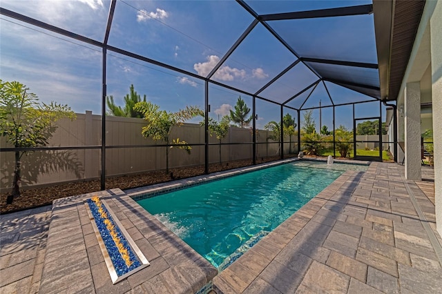 view of swimming pool featuring a lanai, a patio area, a fenced backyard, and a fenced in pool