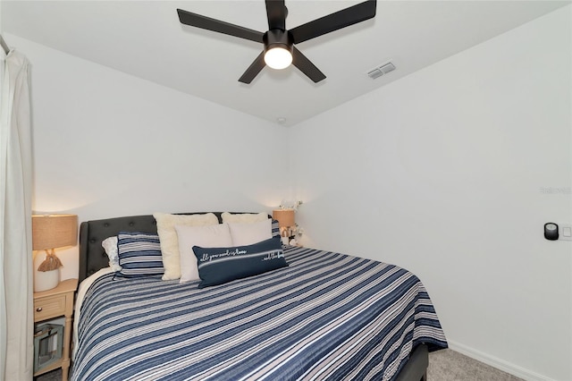 carpeted bedroom featuring baseboards, visible vents, and a ceiling fan