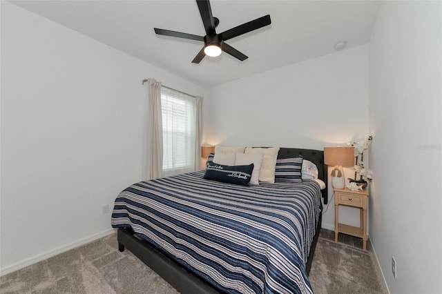 bedroom with ceiling fan, carpet flooring, and baseboards