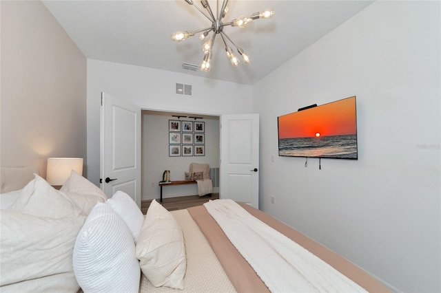 bedroom with a chandelier and visible vents