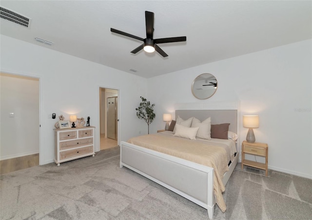 bedroom with carpet floors, baseboards, visible vents, and a ceiling fan